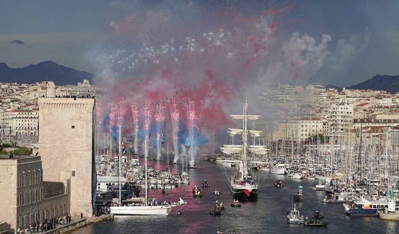 Fireworks go off as the Belem, the three-masted sailing ship bringing the Olympic flame from Greece, enters the Old Port in Marseille, southern France, Wednesday, May 8, 2024. After leaving Marseille, a vast relay route is undertaken before the torch odyssey ends on July 27 in Paris. The Paris 2024 Olympic Games will run from July 26 to Aug.11, 2024. (AP Photo/Laurent Cipriani)