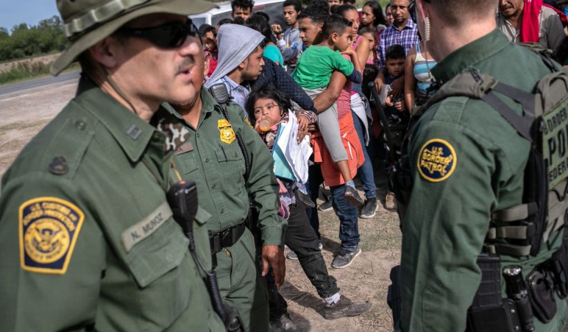 LOS EBANOS, TEXAS - JULY 02: U.S. Border Patrol agents watch over immigrants after taking them into custody on July 02, 2019 in Los Ebanos, Texas. Hundreds of immigrants, most from Central America, turned themselves in to border agents after rafting across the Rio Grande from Mexico to seek political asylum in the United States. (Photo by John Moore/Getty Images)