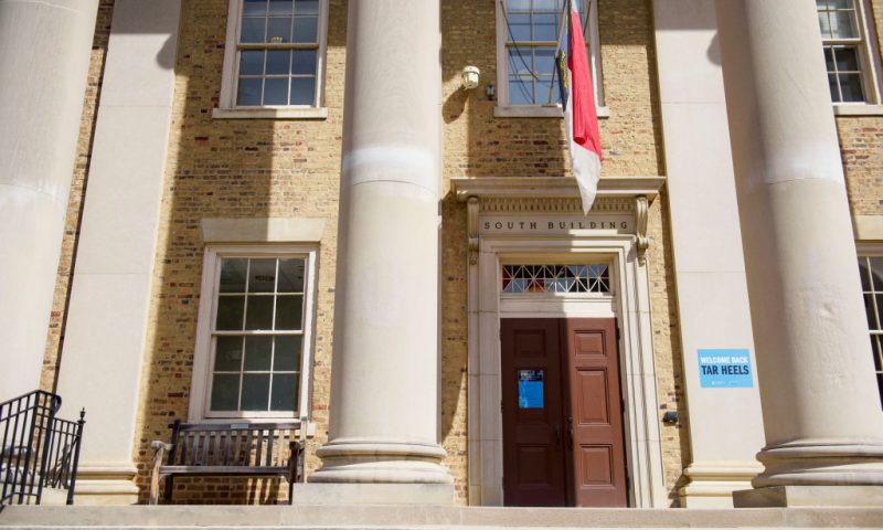 A mostly empty campus with welcome back and COVID-19-19 protocol signs is seen at the University of North Carolina at Chapel Hill on August 18, 2020 in Chapel Hill, North Carolina. The school halted in-person classes and reverted back to online courses after a rise in the number of COVID-19 cases over the past week. (Photo by Melissa Sue Gerrits/Getty Images)