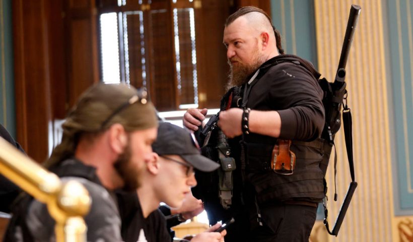 William Null (R) stands in the gallery of the Michigan Senate Chamber during the American Patriot Rally, organized by Michigan United for Liberty, to demand the reopening of businesses on the steps of the Michigan State Capitol in Lansing, Michigan, on April 30, 2020. Others are unidentified. - Thirteen men, including members of two right-wing militias, have been arrested for plotting to kidnap Michigan Governor Gretchen Whitmer and "instigate a civil war", Michigan Attorney General Dana Nessel announced on October 8, 2020. The Nulls were charged for their alleged roles in the plot to kidnap Whitmer, according to the FBI. The brothers are charged with providing support for terroristic acts and felony weapons charges. (Photo by JEFF KOWALSKY / AFP) (Photo by JEFF KOWALSKY/AFP via Getty Images)