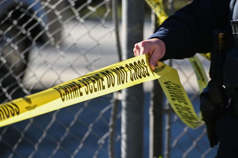 A San Mateo County Sheriff officer puts up police tape at a crime scene after a shooting at the Spanish Town shops in Half Moon Bay, California, on January 24, 2023. - A suspected gunman was in custody Monday over the killing of seven people in a rural community in northern California, just two days after a mass shooting at a Lunar New Year celebration near Los Angeles. (Photo by Samantha Laurey / AFP) (Photo by SAMANTHA LAUREY/AFP via Getty Images)