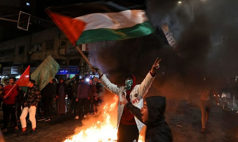 Palestinians celebrate in Gaza City on January 27, 2023, following a shooting attack by a Palestinian gunman outside an east Jerusalem synagogue. (Photo by MAHMUD HAMS / AFP) (Photo by MAHMUD HAMS/AFP via Getty Images)