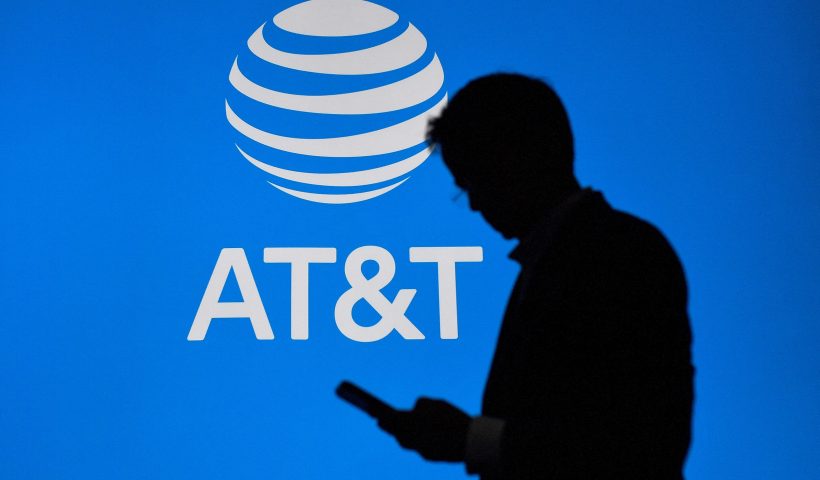 A visitor walks past US multinational telecommunications AT&T logo at the Mobile World Congress (MWC), the telecom industry's biggest annual gathering, in Barcelona on February 27, 2023. (Photo by Pau BARRENA / AFP) (Photo by PAU BARRENA/AFP via Getty Images)