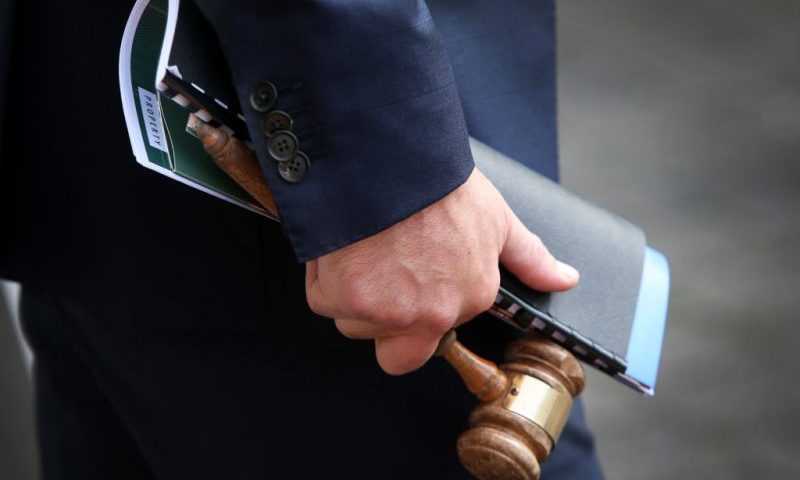 Auctioneer Jesse Davidson holds a gavel during an auction of a residential property in the suburb of Strathfield on May 08, 2021 in Sydney, Australia. Property prices continue to rise across Australia with house prices up almost 27 percent compared to five years ago. Record low interest rates have also seen a surge in home loan applications in the last year. (Photo by Lisa Maree Williams/Getty Images)