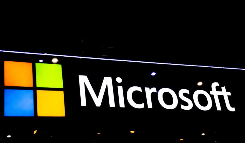 BARCELONA, SPAIN - FEBRUARY 28: A logo sits illuminated outside the Microsoft booth at the SK telecom booth on day 1 of the GSMA Mobile World Congress on February 28, 2022 in Barcelona, Spain. The annual Mobile World Congress hosts some of the world's largest communications companies, with many unveiling their latest phones and wearables gadgets like foldable screens. (Photo by David Ramos/Getty Images)