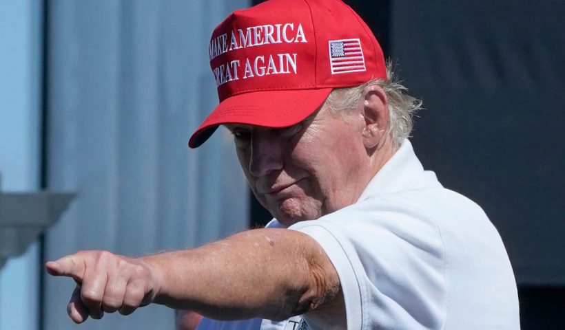 TOPSHOT - Former US President Donald Trump points at the crowd as he attends Round 3 of the LIV Golf-Bedminster 2023 at the Trump National in Bedminster, New Jersey on August 13, 2023. Donald Trump was indicted August 14, 2023 on charges of racketeering and a string of election crimes after a sprawling two-year probe into his efforts to overturn his 2020 defeat to Joe Biden in the US state of Georgia, according to a court filing.