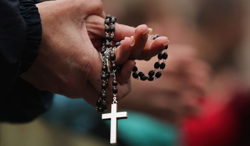 VATICAN CITY, VATICAN - MARCH 13: A woman holds rosary beads while she prays and waits for smoke to emanate from the chimney on the roof of the Sistine Chapel which will indicate whether or not the College of Cardinals have elected a new Pope on March 13, 2013 in Vatican City, Vatican. Pope Benedict XVI's successor is being chosen by the College of Cardinals in Conclave in the Sistine Chapel. The 115 cardinal-electors, meeting in strict secrecy, will need to reach a two-thirds-plus-one vote majority to elect the 266th Pontiff. (Photo by Dan Kitwood/Getty Images)