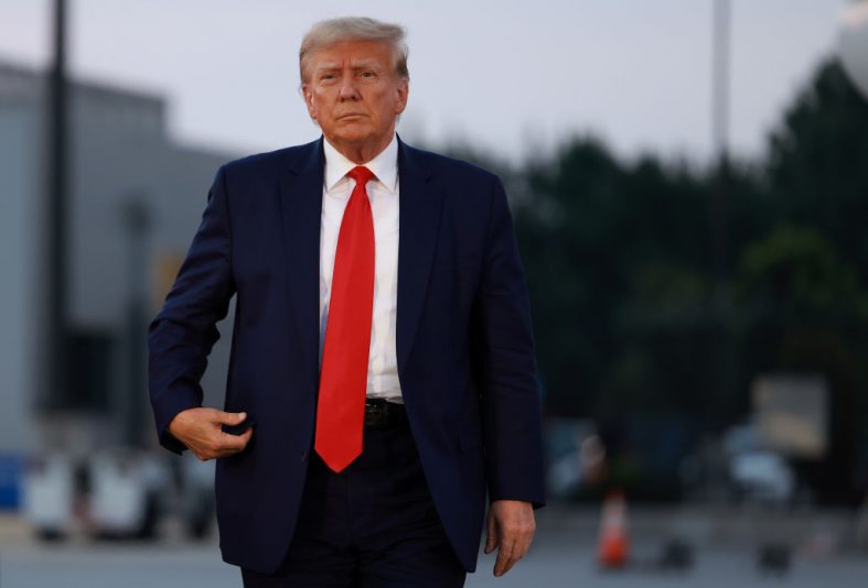 Former U.S. President Donald Trump arrives to depart at Atlanta Hartsfield-Jackson International Airport after being booked at the Fulton County jail on August 24, 2023 in Atlanta, Georgia. Trump was booked on multiple charges related to an alleged plan to overturn the results of the 2020 presidential election in Georgia. (Photo by Joe Raedle/Getty Images)