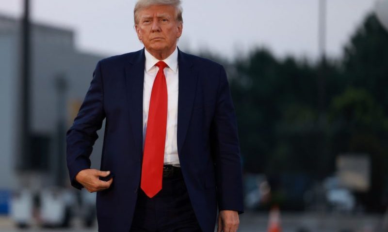 Former U.S. President Donald Trump arrives to depart at Atlanta Hartsfield-Jackson International Airport after being booked at the Fulton County jail on August 24, 2023 in Atlanta, Georgia. Trump was booked on multiple charges related to an alleged plan to overturn the results of the 2020 presidential election in Georgia. (Photo by Joe Raedle/Getty Images)