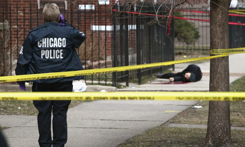 CHICAGO, IL - APRIL 01: (EDITORS NOTE: Image contains graphic content.) Chicago police investigate the murder of a 24-year-old man who was shot and killed on South Eberhart Avenue on the city's South Side April 1, 2013 in Chicago, Illinois. According to published reports, the man was the 73rd homicide victim and the 39th victim under the age of 25 in Chicago in 2013. (Photo by Scott Olson/Getty Images)