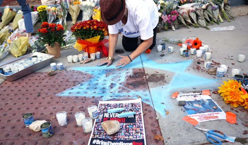 THOUSAND OAKS, CALIFORNIA - NOVEMBER 07: Elena Colombo creates a Star of David at a makeshift memorial at the site of an altercation between 69-year-old Paul Kessler, who was Jewish, and pro-Palestinian protestor on November 7, 2023 in Thousand Oaks, California. Kessler died of a head injury he sustained from falling during the confrontation at dueling Israeli and Palestinian protests on November 5. The death was ruled a homicide by the Ventura County Medical Examiner’s Office. (Photo by Mario Tama/Getty Images)