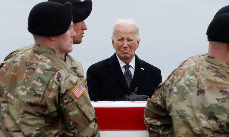 DOVER, DELAWARE - FEBRUARY 02: U.S. President Joe Biden places his hand over his heart as a U.S. Army carry team moves a flagged draped transfer case containing the remains of Army Sgt. Breonna Moffett during a dignified transfer at Dover Air Force Base on February 02, 2024 in Dover, Delaware. U.S. Army Sgt. William Rivers, Sgt. Breonna Moffett, Sgt. Kennedy Sanders were killed in addition to 40 other troops were injured during a drone strike in Jordan. (Photo by Kevin Dietsch/Getty Images)