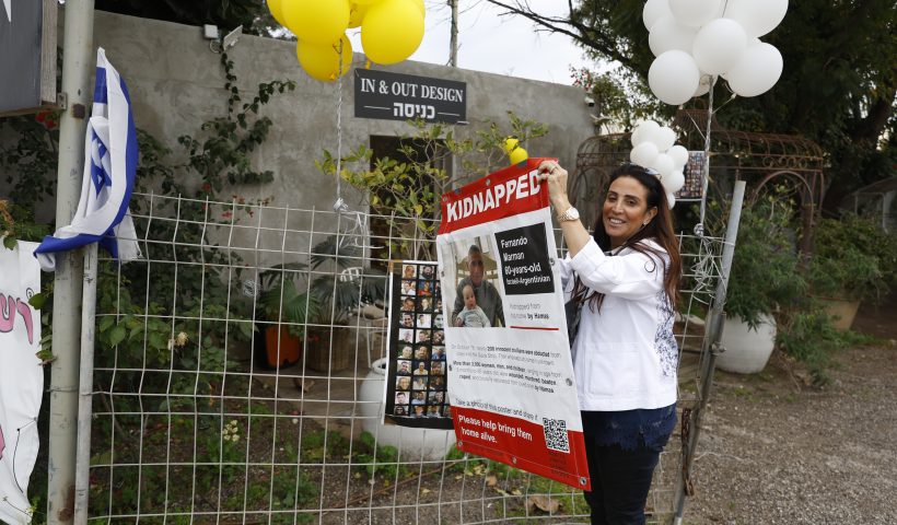 TEL AVIV, ISRAEL - FEBRUARY 12: Hagit Matzliah takes off a kidnapped sign from the store where rescued hostage, Fernando Marman, worked in Ramat Hasharon on February 12, 2024 in Tel Aviv, Israel. The Israeli military says it has rescued two hostages from captivity in Rafah, whilst two 21-year old IDF soldiers were killed in overnight fighting in the Gaza Strip. The IDF has now rescued three hostages through military operations since Oct. 7, as PM Netanyahu faces pressure from relatives of freed hostages to secure the release of the remaining captives through negations with Hamas. (Photo by Amir Levy/Getty Images)