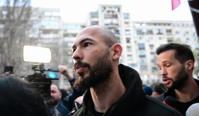 British-US former professional kickboxer and controversial influencer Andrew Tate (L) and his brother Tristan Tate (R) leave after having been released from detention in Bucharest, Romania on March 12, 2024, after they appeared in a court after Romanian police detained them over UK sex offence charges. A Bucharest court on March 12 granted a request to extradite controversial influencer Andrew Tate to the UK over sex offence charges, but only after the conclusion of legal proceedings in Romania in a separate case. The Bucharest appeals court ruling "orders the execution of the warrant of arrest issued on 19 January 2024" by the Westminster Magistrates' Court, but postpones extradition "until the final resolution of the case" in Romania, which could take years. (Photo by Daniel MIHAILESCU / AFP) (Photo by DANIEL MIHAILESCU/AFP via Getty Images)