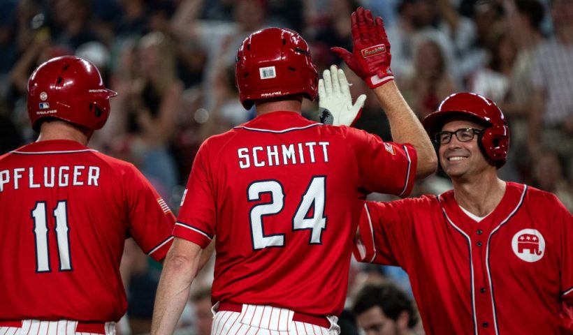 WASHINGTON, DC - JUNE 12: Rep. August Pfluger (R-TX) and Sen. Eric Schmitt (R-MO) celebrate with Rep. Jake Ellzey (R-TX) during the Congressional Baseball Game for Charity at National's Park on June 12, 2024 in Washington, DC. The annual bipartisan game was first played in 1909. (Photo by Kent Nishimura/Getty Images)