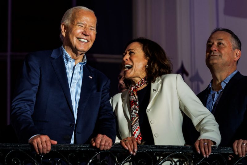 WASHINGTON, DC - JULY 04: President Joe Biden and Vice President Kamala Harris laugh as they view the fireworks on the National Mall from the White House balcony during a 4th of July event on the South Lawn of the White House on July 4, 2024 in Washington, DC. The President is hosting the Independence Day event for members of the military and their families. (Photo by Samuel Corum/Getty Images)