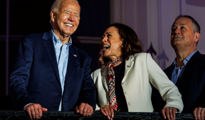 WASHINGTON, DC - JULY 04: President Joe Biden and Vice President Kamala Harris laugh as they view the fireworks on the National Mall from the White House balcony during a 4th of July event on the South Lawn of the White House on July 4, 2024 in Washington, DC. The President is hosting the Independence Day event for members of the military and their families. (Photo by Samuel Corum/Getty Images)