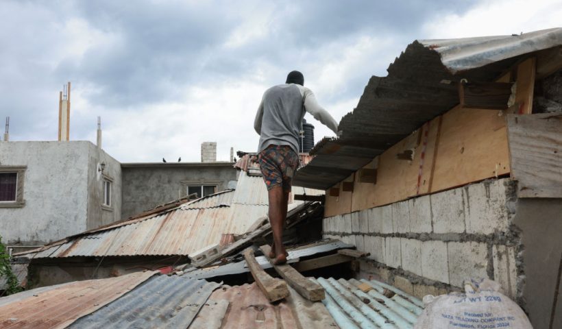 KINGSTON, JAMAICA - JULY 03: Zach Willams places sandbags along the roof as he makes last-minute preparations for the arrival of Hurricane Beryl on July 03, 2024 in Kingston, Jamaica. Category 4 storm Beryl has caused widespread damage in several island nations as it continues to cross the Caribbean. (Photo by Joe Raedle/Getty Images)