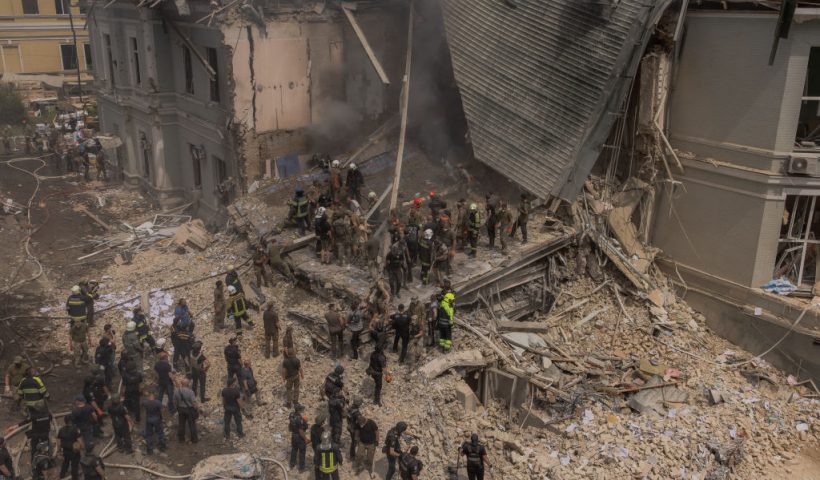 Emergency and rescue personnel along with medics and others clear the rubble of the destroyed building of Ohmatdyt Children's Hospital following a Russian missile attack in the Ukrainian capital of Kyiv on July 8, 2024, amid Russian invasion in Ukraine. Russia launched more than 40 missiles at several cities across Ukraine on July 8, 2024 in an attack that killed at least 20 people and smashed into a children's hospital in Kyiv, officials said. (Photo by Roman PILIPEY / AFP) (Photo by ROMAN PILIPEY/AFP via Getty Images)