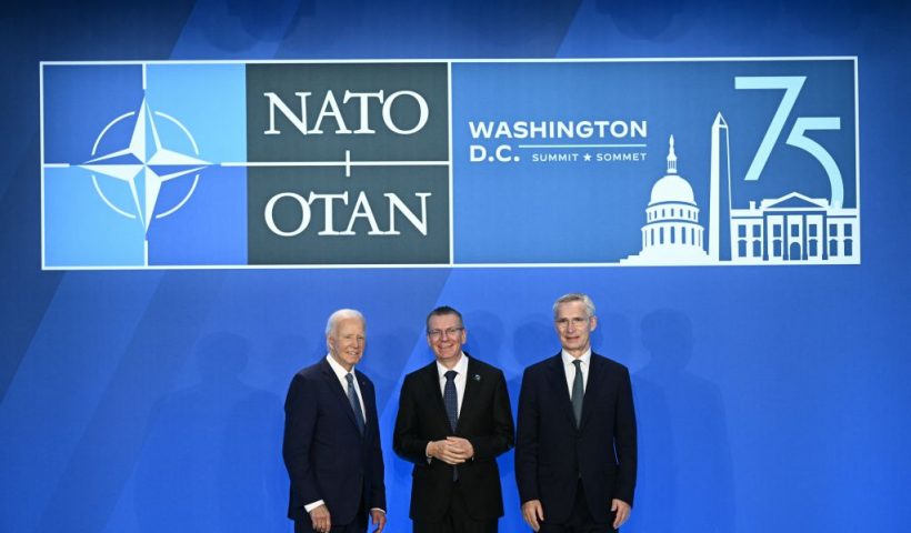 Latvia's President Edgars Rinkevics (C) poses with US President Joe Biden (L) and NATO Secretary General Jens Stoltenberg during the NATO 75th anniversary summit at the Walter E. Washington Convention Center in Washington, DC, on July 10, 2024. (Photo by Brendan SMIALOWSKI / AFP) (Photo by BRENDAN SMIALOWSKI/AFP via Getty Images)