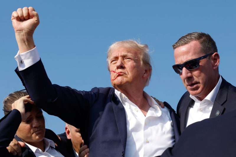 BUTLER, PENNSYLVANIA - JULY 13: Republican presidential candidate former President Donald Trump pumps his fist as he is rushed offstage during a rally on July 13, 2024 in Butler, Pennsylvania. Butler County district attorney Richard Goldinger said the shooter is dead after injuring former U.S. President Donald Trump, killing one audience member and injuring another in the shooting. (Photo by Anna Moneymaker/Getty Images)