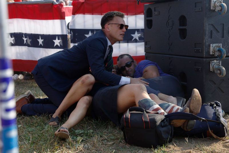 BUTLER, PENNSYLVANIA - JULY 13: A member of the Trump campaign and members of the crowd are seen at Republican presidential candidate former President Donald Trump's rally on July 13, 2024 in Butler, Pennsylvania. Butler County district attorney Richard Goldinger said the shooter is dead after injuring former U.S. President Donald Trump, killing one audience member and injuring another in the shooting. (Photo by Anna Moneymaker/Getty Images)