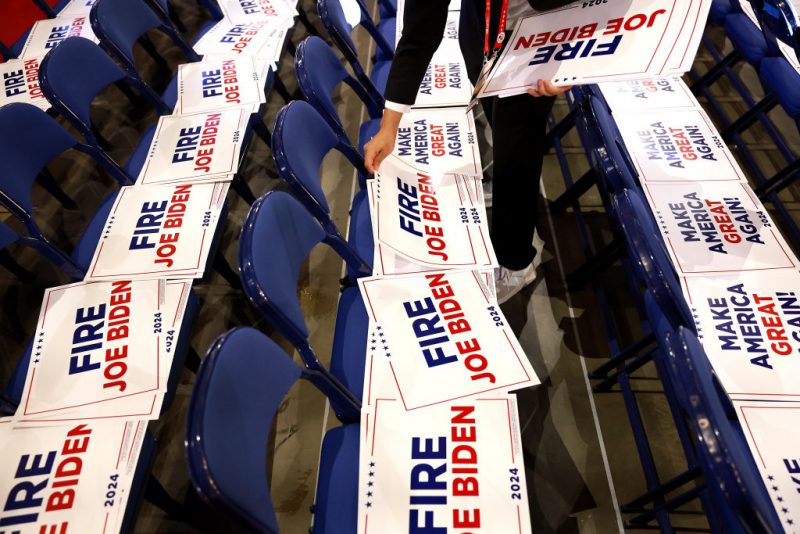 MILWAUKEE, WISCONSIN - JULY 18: Signs reading "Fire Joe Biden" are seen during preparations for the fourth day of the Republican National Convention at the Fiserv Forum on July 18, 2024 in Milwaukee, Wisconsin. Delegates, politicians, and the Republican faithful are in Milwaukee for the annual convention, concluding with former President Donald Trump accepting his party's presidential nomination. The RNC takes place from July 15-18. (Photo by Joe Raedle/Getty Images)