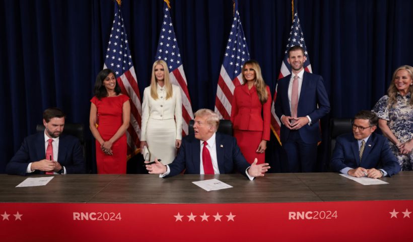 MILWAUKEE, WISCONSIN - JULY 18: Republican presidential candidate, former U.S. President Donald Trump signs a document officially accepting the Republican presidential nomination as his family looks on during the fourth day of the Republican National Convention at the Fiserv Forum on July 18, 2024 in Milwaukee, Wisconsin. Delegates, politicians, and the Republican faithful are in Milwaukee for the annual convention, concluding with former President Donald Trump accepting his party's presidential nomination. The RNC takes place from July 15-18. (Photo by Win McNamee/Getty Images)