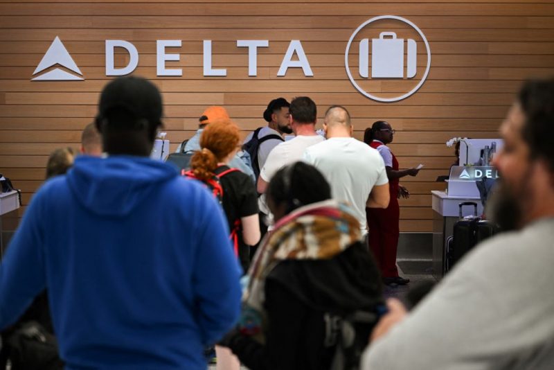 People looking for missing bags wait in line to speak with Delta Air Lines baggage in the Delta Air Lines baggage claim area Los Angeles International Airport (LAX) on July 24, 2024 in Los Angeles, California. The United States Department of Transportation (USDOT) announced an investigation into Delta Air Lines to comply with passenger protection laws following the CrowdStrike global software outage that disrupted airlines, banks, TV channels and other businesses worldwide.CrowdStrike, the cybersecurity company that caused a global computer outage last week, on on July 24, 2024 said that the breakdown stemmed from a flaw in its test software. In an incident report, the company said the glitch was pushed out to millions of Windows computers and that the company will change the way it handles such updates in the future. (Photo by Patrick T. Fallon / AFP) (Photo by PATRICK T. FALLON/AFP via Getty Images)