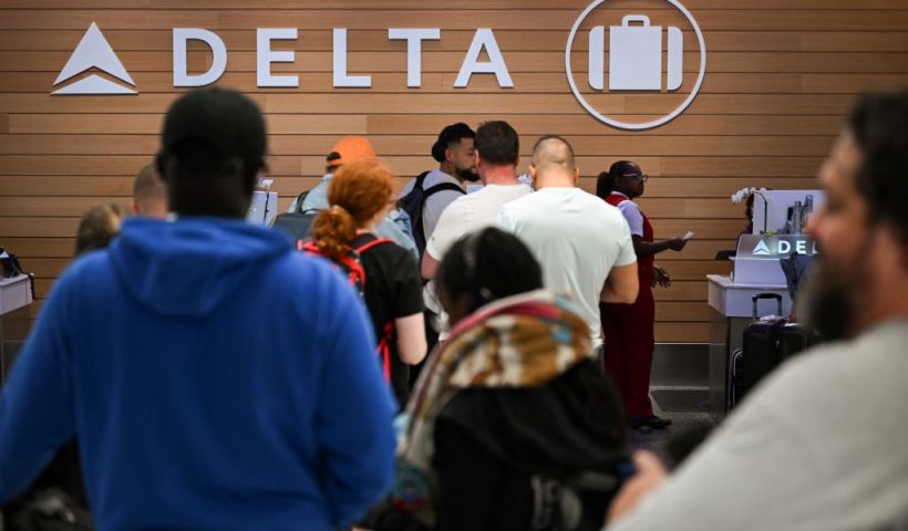 People looking for missing bags wait in line to speak with Delta Air Lines baggage in the Delta Air Lines baggage claim area Los Angeles International Airport (LAX) on July 24, 2024 in Los Angeles, California. The United States Department of Transportation (USDOT) announced an investigation into Delta Air Lines to comply with passenger protection laws following the CrowdStrike global software outage that disrupted airlines, banks, TV channels and other businesses worldwide.CrowdStrike, the cybersecurity company that caused a global computer outage last week, on on July 24, 2024 said that the breakdown stemmed from a flaw in its test software. In an incident report, the company said the glitch was pushed out to millions of Windows computers and that the company will change the way it handles such updates in the future. (Photo by Patrick T. Fallon / AFP) (Photo by PATRICK T. FALLON/AFP via Getty Images)