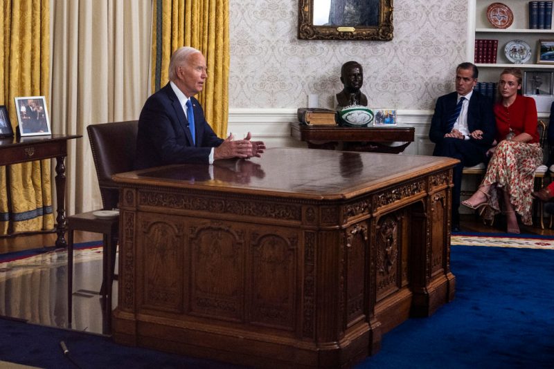 US President Joe Biden (L) speaks during an address to the nation about his decision to not seek reelection as his son Hunter Biden (C) and Hunter's wife Melissa Cohen Biden (R) listen, in the Oval Office at the White House in Washington, DC, on July 24, 2024. US President Joe Biden will give an Oval Office speech July 24, 2024 to explain his historic decision to drop out of the 2024 election and pass the torch to Kamala Harris, with the White House denying any cover up over his health. In his first address to the nation since quitting the race, the 81-year-old is expected to burnish his legacy and deny he will spend six months as a lame duck president. (Photo by Jim WATSON / AFP) (Photo by JIM WATSON/AFP via Getty Images)