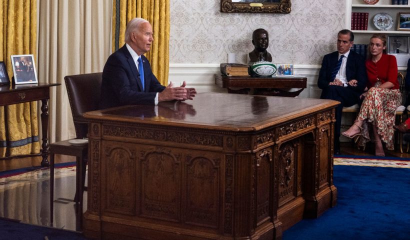 US President Joe Biden (L) speaks during an address to the nation about his decision to not seek reelection as his son Hunter Biden (C) and Hunter's wife Melissa Cohen Biden (R) listen, in the Oval Office at the White House in Washington, DC, on July 24, 2024. US President Joe Biden will give an Oval Office speech July 24, 2024 to explain his historic decision to drop out of the 2024 election and pass the torch to Kamala Harris, with the White House denying any cover up over his health. In his first address to the nation since quitting the race, the 81-year-old is expected to burnish his legacy and deny he will spend six months as a lame duck president. (Photo by Jim WATSON / AFP) (Photo by JIM WATSON/AFP via Getty Images)