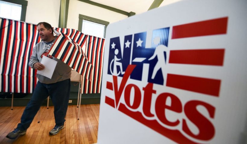 TOPSHOT - A man walks out of a booth with his ballot for the first US presidential primary at the town hall in Canterbury, New Hampshire, on February 9, 2016. - New Hampshire began voting on February 9 in the first US presidential primary with Republican Donald Trump calling on supporters to propel him to victory and Democrat Bernie Sanders primed to upstage Hillary Clinton. The northeastern state, home to just 1.3 million people, sets the tone for the primaries and could shake out a crowded Republican field of candidates pitting Trump and arch-conservative Senator Ted Cruz against more establishment candidates led by Senator Marco Rubio. (Photo by Jewel Samad / AFP) (Photo by JEWEL SAMAD/AFP via Getty Images)