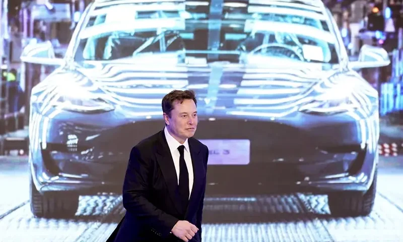 Tesla Inc CEO Elon Musk walks next to a screen showing an image of Tesla Model 3 car during an opening ceremony for Tesla China-made Model Y program in Shanghai, China January 7, 2020. REUTERS/Aly Song//File Photo