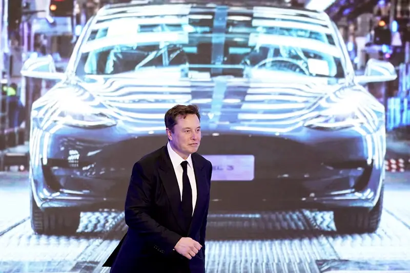 Tesla Inc CEO Elon Musk walks next to a screen showing an image of Tesla Model 3 car during an opening ceremony for Tesla China-made Model Y program in Shanghai, China January 7, 2020. REUTERS/Aly Song//File Photo