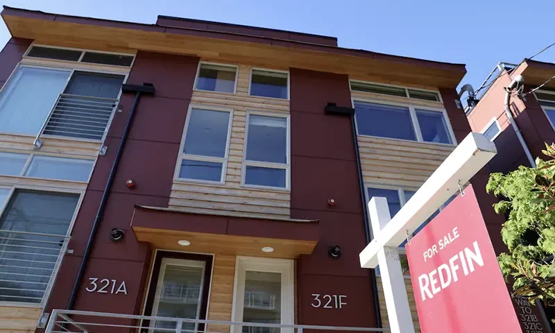 A "For Sale" sign is posted outside a residential home in the Queen Anne neighborhood of Seattle, Washington, U.S. May 14, 2021. REUTERS/Karen Ducey/File Photo