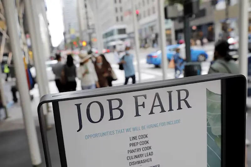 Signage for a job fair is seen on 5th Avenue after the release of the jobs report in Manhattan, New York City, U.S., September 3, 2021. REUTERS/Andrew Kelly/File Photo