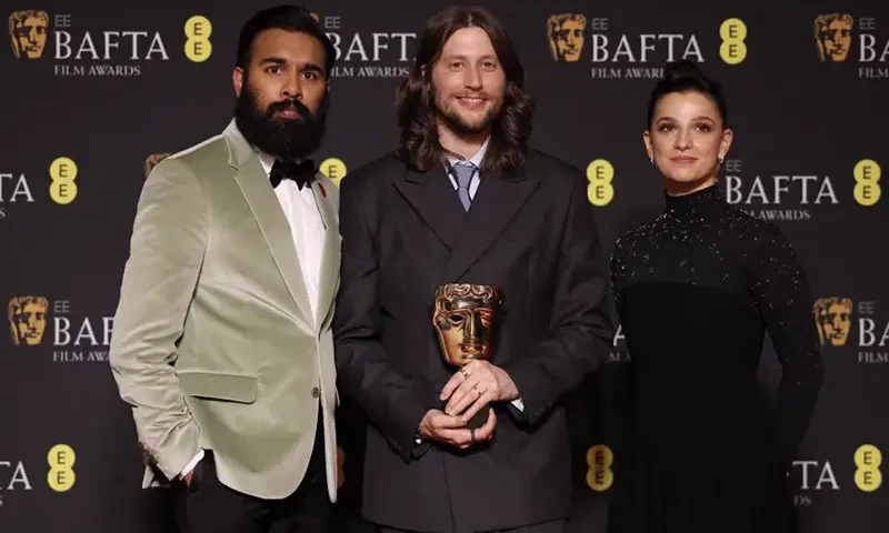 Ludwig Goransson poses in the winner's room with his award for Original Score for "Oppenheimer" next to Himesh Patel and Marisa Abela during the 2024 British Academy of Film and Television Awards (BAFTA) at the Royal Festival Hall in the Southbank Centre, London, Britain, February 18, 2024. REUTERS/Hollie Adams