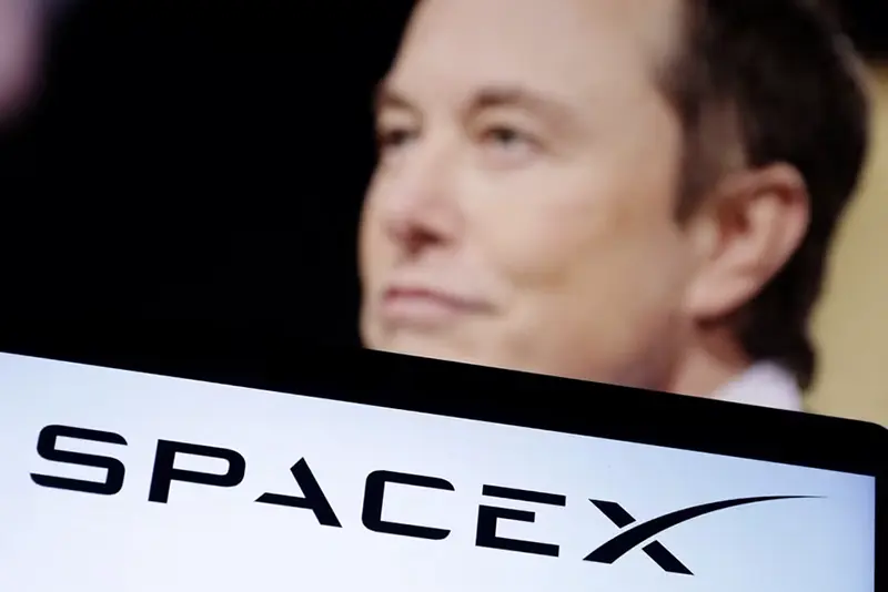 SpaceX logo and Elon Musk photo are seen in this illustration taken, December 19, 2022. REUTERS/Dado Ruvic/Illustration/File Photo