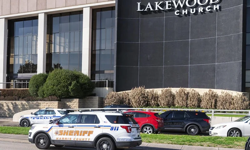 Emergency vehicles line the feeder road outside Lakewood Church during a reported active shooter event, Sunday, Feb. 11, 2024, in Houston. (Kirk Sides/Houston Chronicle via AP)