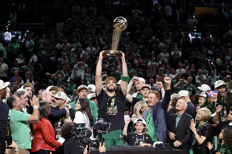 Boston Celtics forward Jayson Tatum (0) lifts the trophy after winning the 2024 NBA Finals against the Dallas Mavericks at TD Garden. Mandatory Credit: Peter Casey-USA TODAY Sports