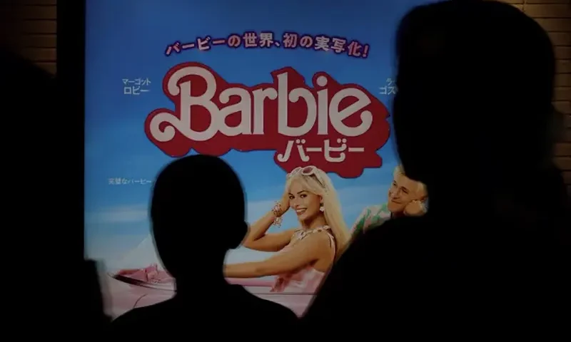 People walk past a promotional poster of film "Barbie" in Tokyo, Japan, August 3, 2023. REUTERS/Kim Kyung-Hoon/File Photo