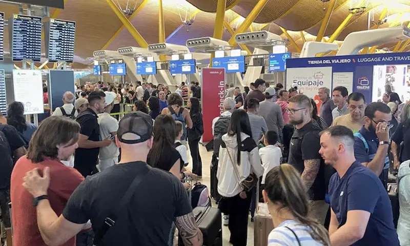 Passengers wait at Barajas Airport, as Spanish airport operator Aena on Friday reported a computer systems "incident" at all Spanish airports which may cause flight delays, in Madrid, Spain July 19, 2024. REUTERS/Elena Rodriguez