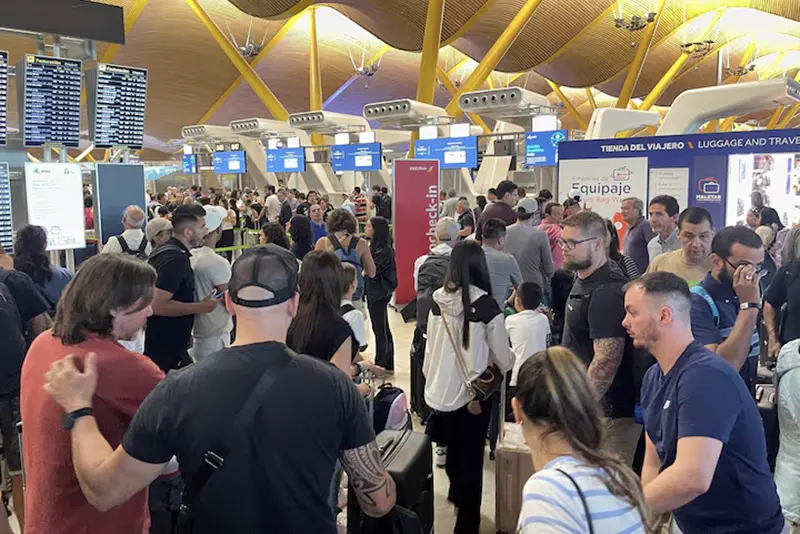 Passengers wait at Barajas Airport, as Spanish airport operator Aena on Friday reported a computer systems "incident" at all Spanish airports which may cause flight delays, in Madrid, Spain July 19, 2024. REUTERS/Elena Rodriguez