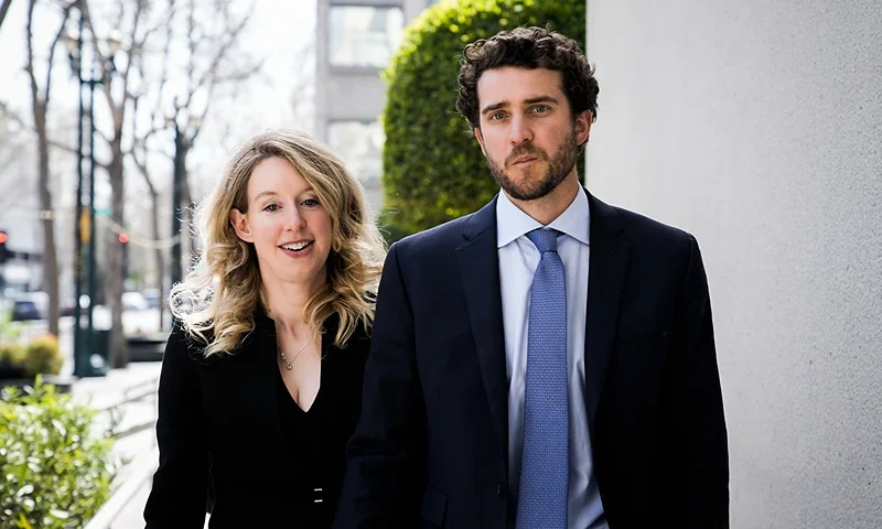 SAN JOSE, CA - MARCH 17: Former Theranos CEO Elizabeth Holmes alongside her boyfriend Billy Evans, leaves a hearing at the Robert E. Peckham U.S. Courthouse on March 17, 2023 in San Jose, California. Holmes appeared in court for a restitution hearing. (Photo by Philip Pacheco/Getty Images)