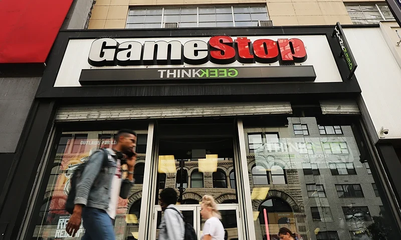 NEW YORK, NEW YORK - SEPTEMBER 16: People pass a GameStop store in lower Manhattan on September 16, 2019 in New York City. GameStop has announced that they will be closing between 180 and 200 stores before the end of the fiscal year due to a drop in sales. (Photo by Spencer Platt/Getty Images)