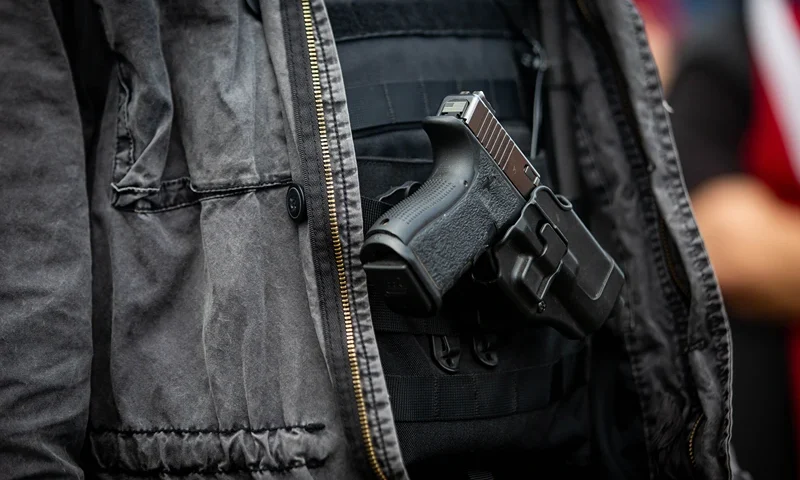 US-VOTE-DEMONSTRATION A man openly carries a handgun during a Proud Boys rally at Delta Park in Portland, Oregon on September 26, 2020. - Far-right group "Proud Boys" members gather in Portland to show support to US president Donald Trump and to condemn violence that have been occurring for more than three months during "Black Lives Matter" and "Antifa" protests. (Photo by Maranie R. STAAB / AFP) (Photo by MARANIE R. STAAB/AFP via Getty Images)