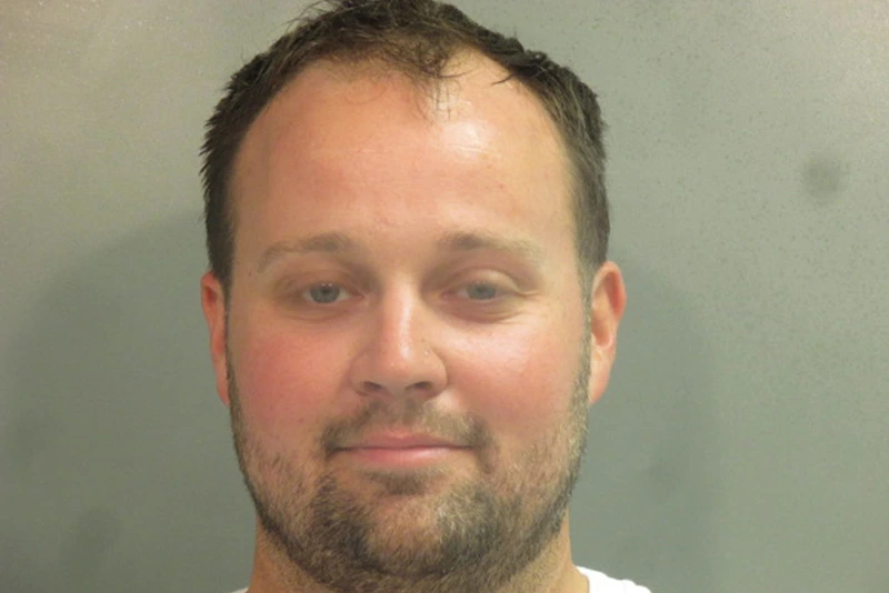 FAYETTEVILLE, AR - APRIL 29: In this handout photo provided by the Washington County Sheriff’s Office, former television personality on "19 Kids And Counting" Josh Duggar poses for a booking photo after his arrest April 29, 2021 in Fayetteville, Arkansas. Duggar was reportedly arrested by federal agents and is being detained on a federal hold. (Photo by Washington County Sheriff’s Office via Getty Images)