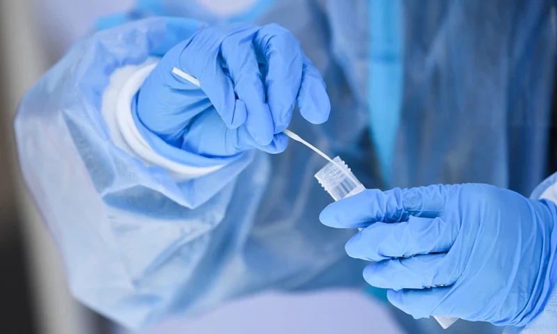 A healthcare worker places a test swab into solution for a PCR Covid-19 test at a Reliant Health Services testing site in Hawthorne, California on January 18, 2022. (Photo by Patrick T. FALLON / AFP) (Photo by PATRICK T. FALLON/AFP via Getty Images)