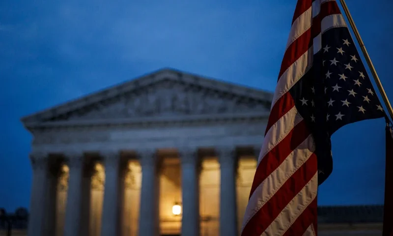 An abortion rights activist flies an upside down US flag, the international sign of distress, outside of the US Supreme Court during a protest in Washington, DC, on June 26, 2022, two days after the US Supreme Court scrapped half-century constitutional protections for the procedure. Elected leaders across the US political divide rallied on June 26 for a long fight ahead on abortion -- state by state and in Congress -- with total bans in force or expected soon in half of the vast country. (Photo by Samuel Corum / AFP) (Photo by SAMUEL CORUM/AFP via Getty Images)